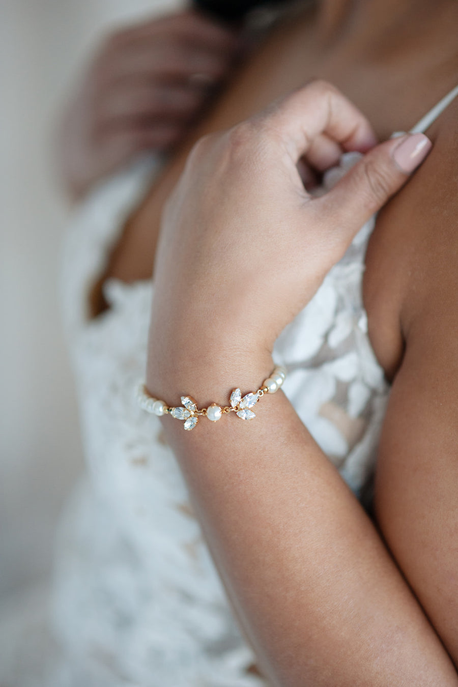 Bride wearing crystal and pearl bridal bracelet by Joanna Bisley Designs.