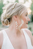Bride wearing long flower bridal earrings by Joanna Bisley designs 