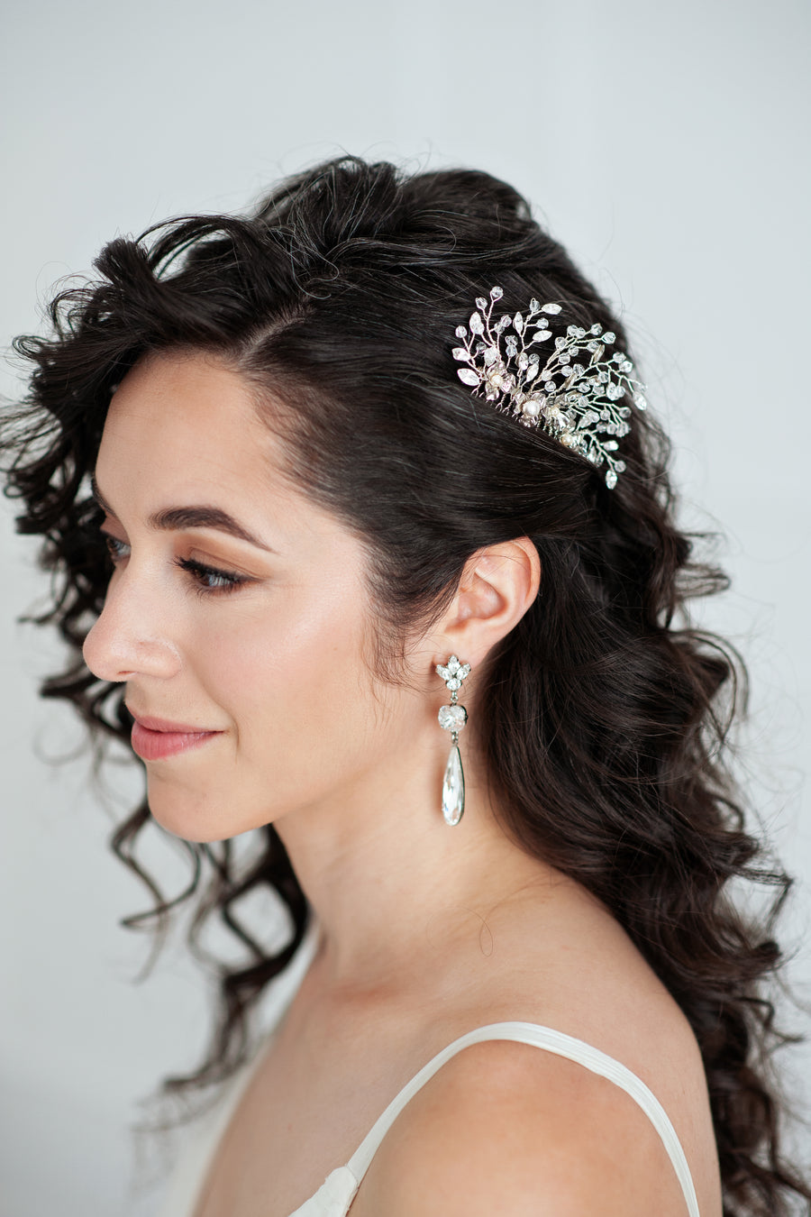 Bride wearing vintage bridal hair comb in crystal and silver by Joanna Bisley Designs.