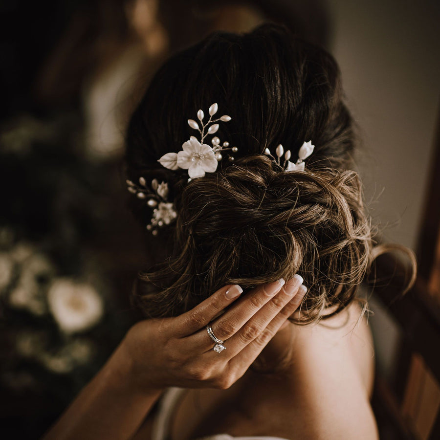 Bridal updo with flower hairpins