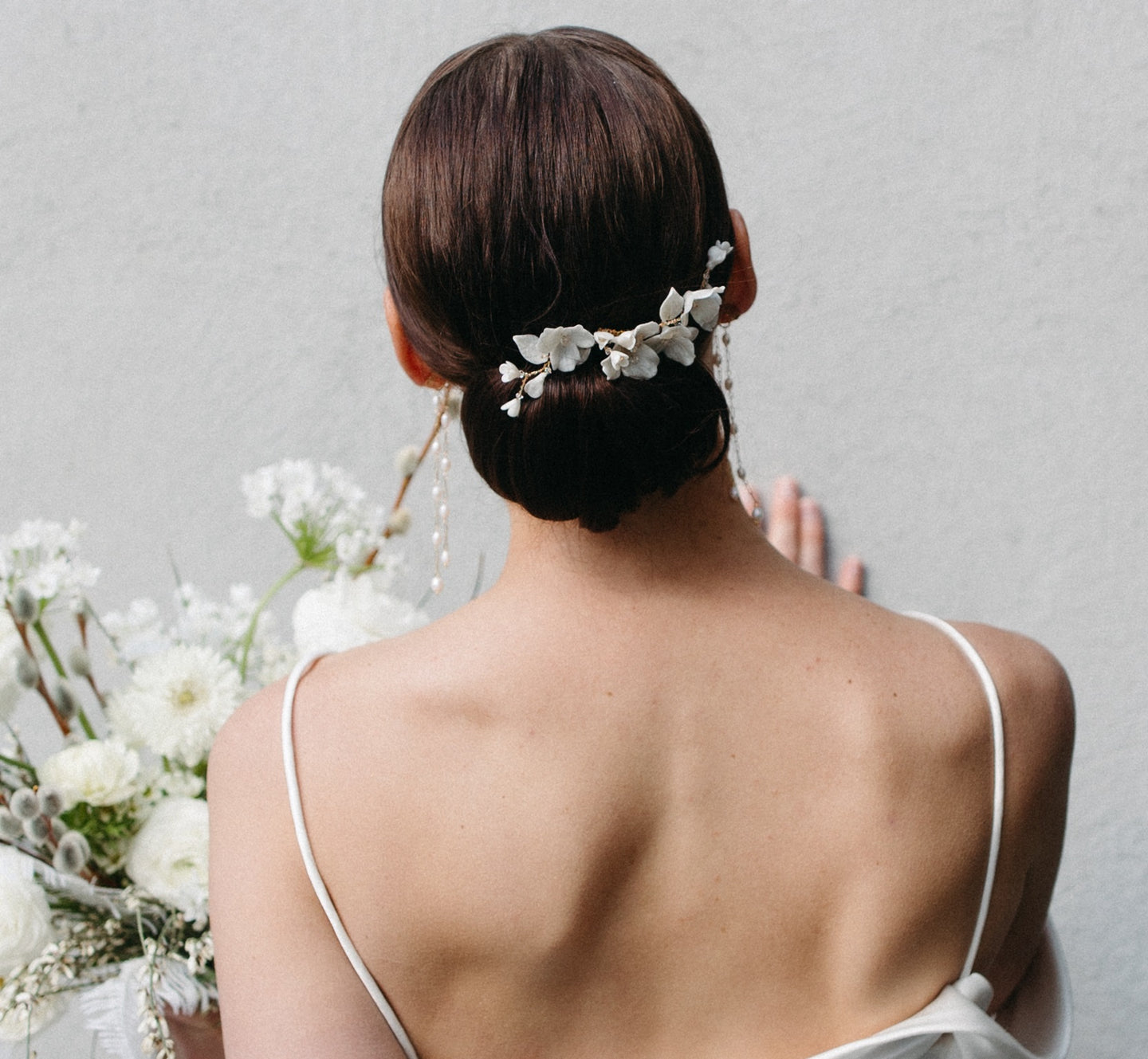Bride with romantic updo wearing a flower comb. 