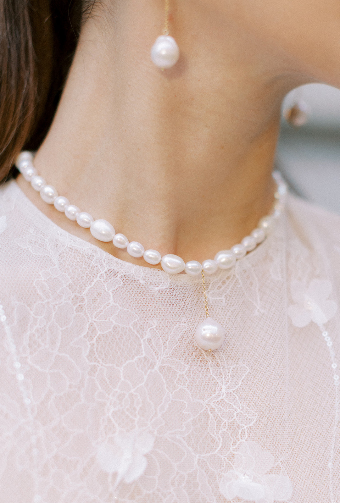 Bride wearing modern baroque pearl bridal choker and matching earrings by Joanna Bisley Designs.