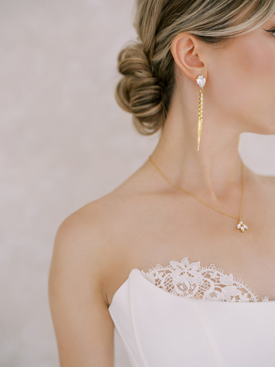 Close up of a bride wearing Swarovski Crystal Tassel Bridal Earrings handmade by Joanna Bisley Designs.