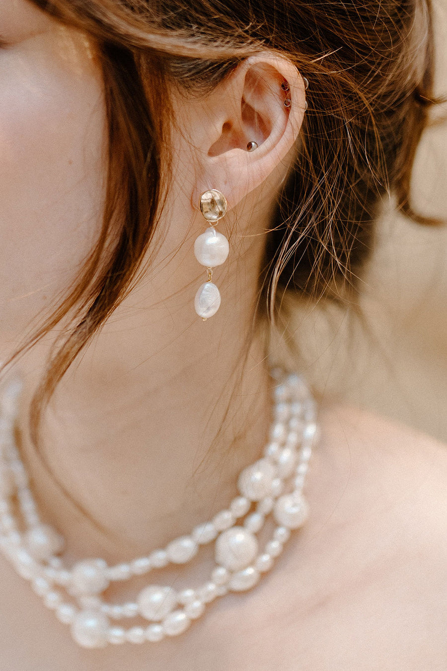 Close up of bride wearing freshwater pearl earrings and baroque bridal necklace by Joanna Bisley Designs