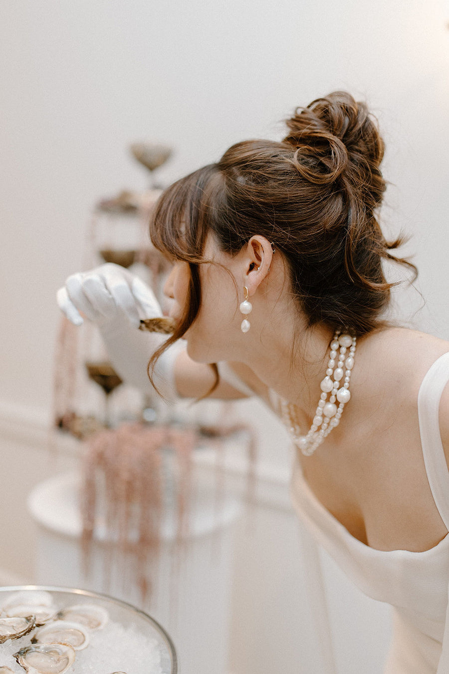 Bride wearing updo with pearl wedding jewelry.