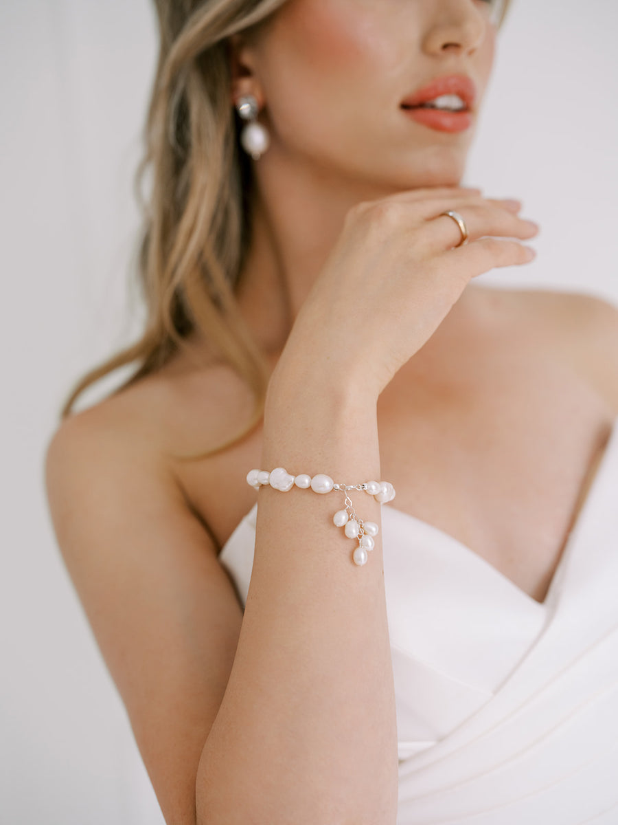 Baroque Pearl and Freshwater Pearl bridal bracelet on bride's wrist.