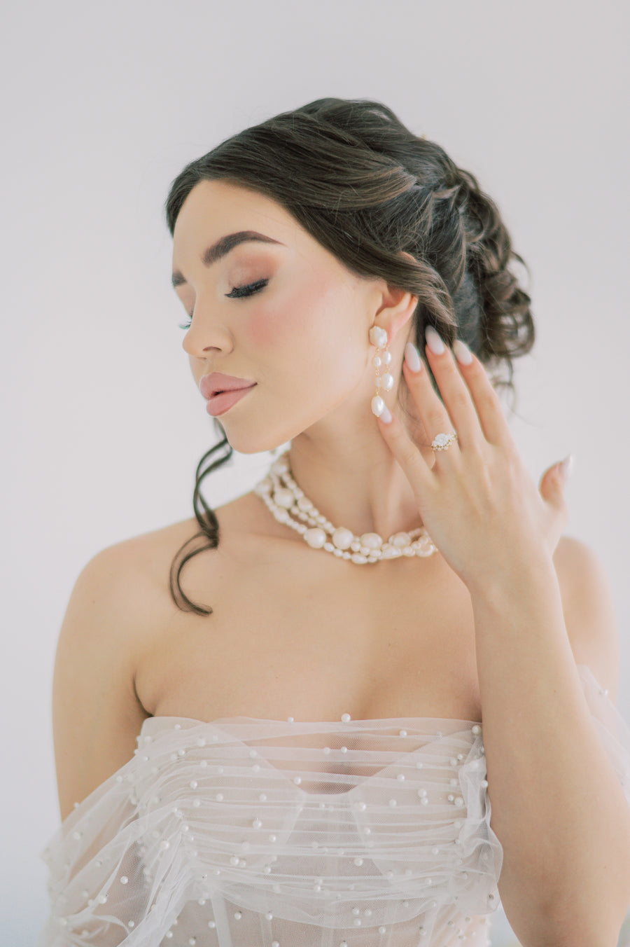 Bride wearing stunning triple strand baroque pearl choker with freshwater pearls by Joanna Bisley Designs. 