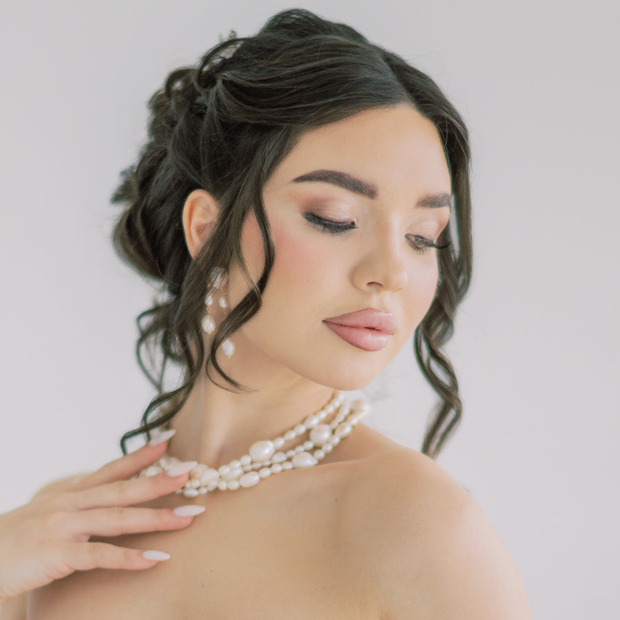 Bride wearing triple strand baroque pearl bridal necklace by Joanna Bisley Designs.