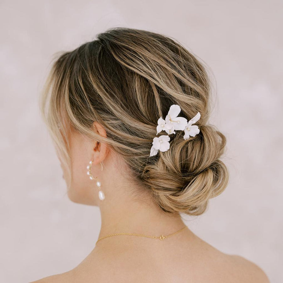Close up of bridal updo adorned with bridal flower hairpins from Joanna Bisley Designs.