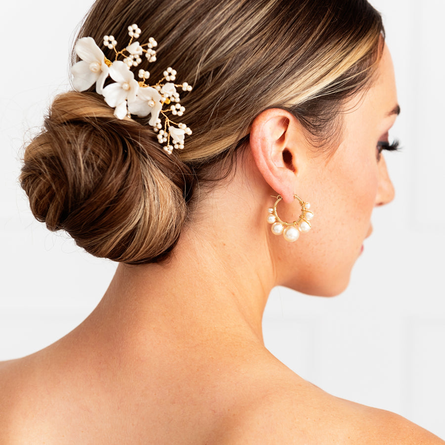 Bride wearing pearl hoop bridal earrings and pearl wedding comb by Joanna Bisley Designs.