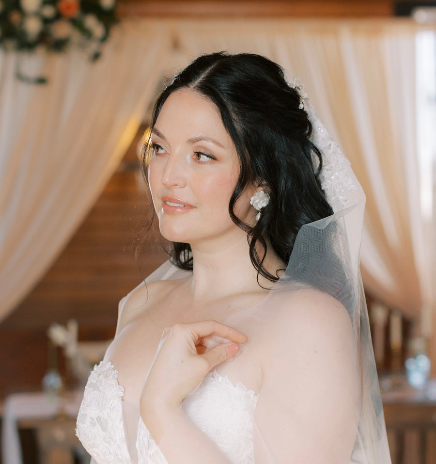 Bride wearing baroque pearl earrings.