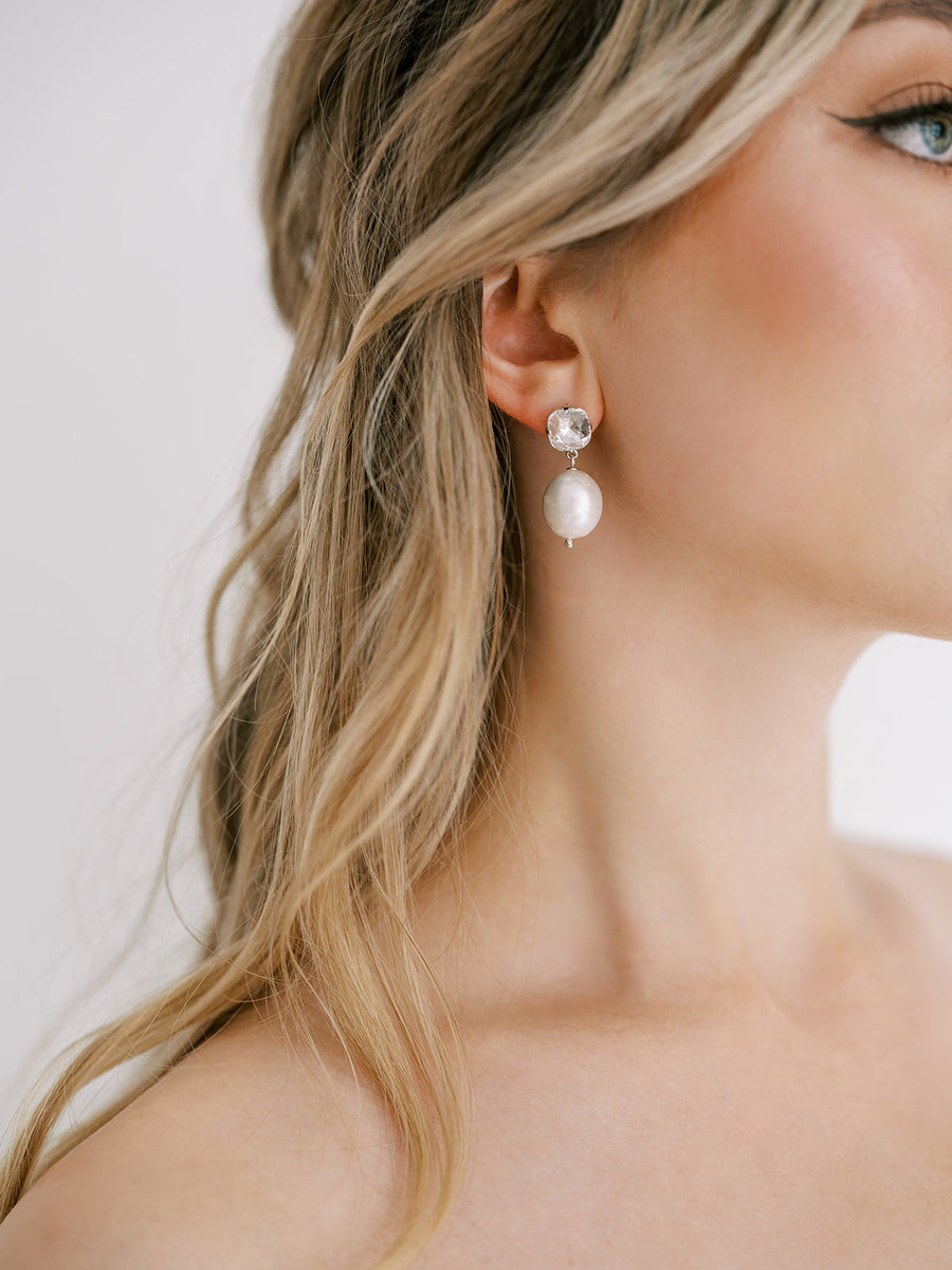 Closeup of baroque pearl and Swarovski Crystal earrings on New York Bride.