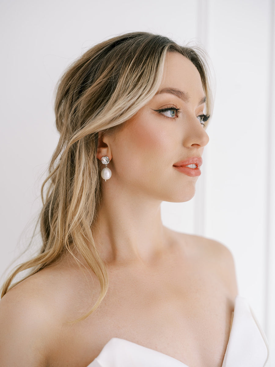 Bridal wearing baroque pearl earrings on Swarovski Crystal stud.
