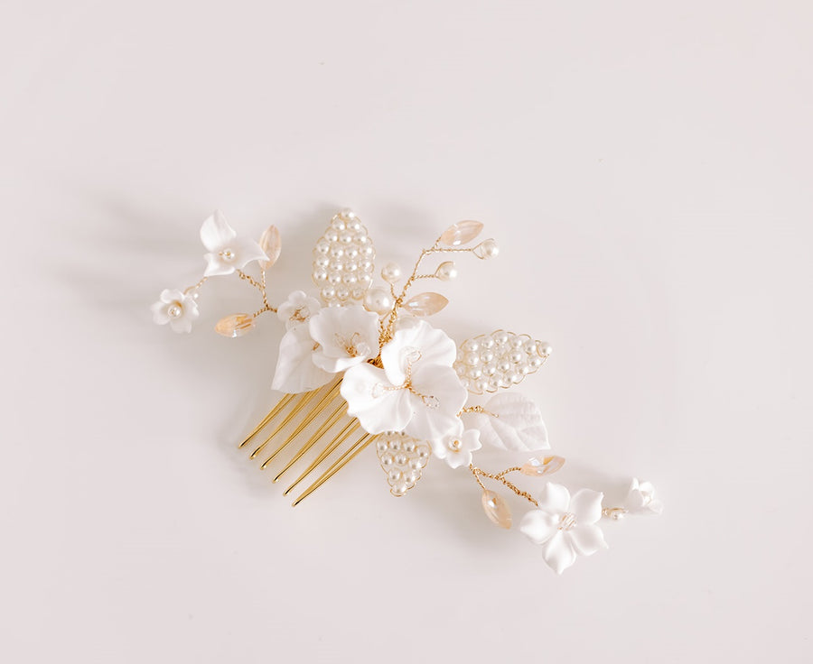 A bridal comb with blush crystals and flowers made by Joanna Bisley Designs.