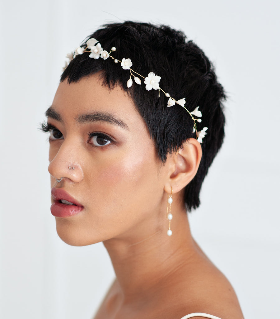 Bride wearing a delicate flower and pearl hairvine by Joanna Bisley Designs