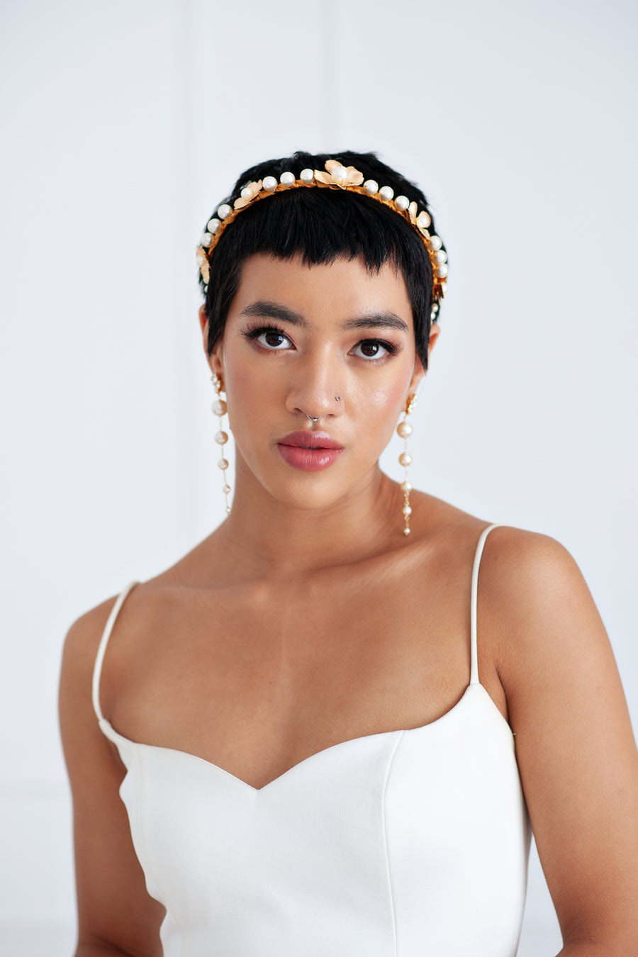 Calgary bride wearing modern pearl statement wedding earrings and flower bridal headband.