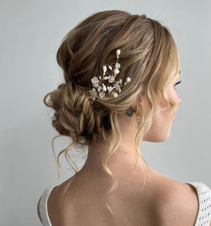 Bride with glamourous bridal updo wearing delicatie wedding hairpins.