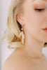Bride wearing modern pearl earrings by Joanna Bisley Designs.
