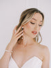 Bride wearing pearl bridal jewelry set.
