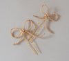 A close up picture of bridal bow hairpins by Joanna Bisley Designs