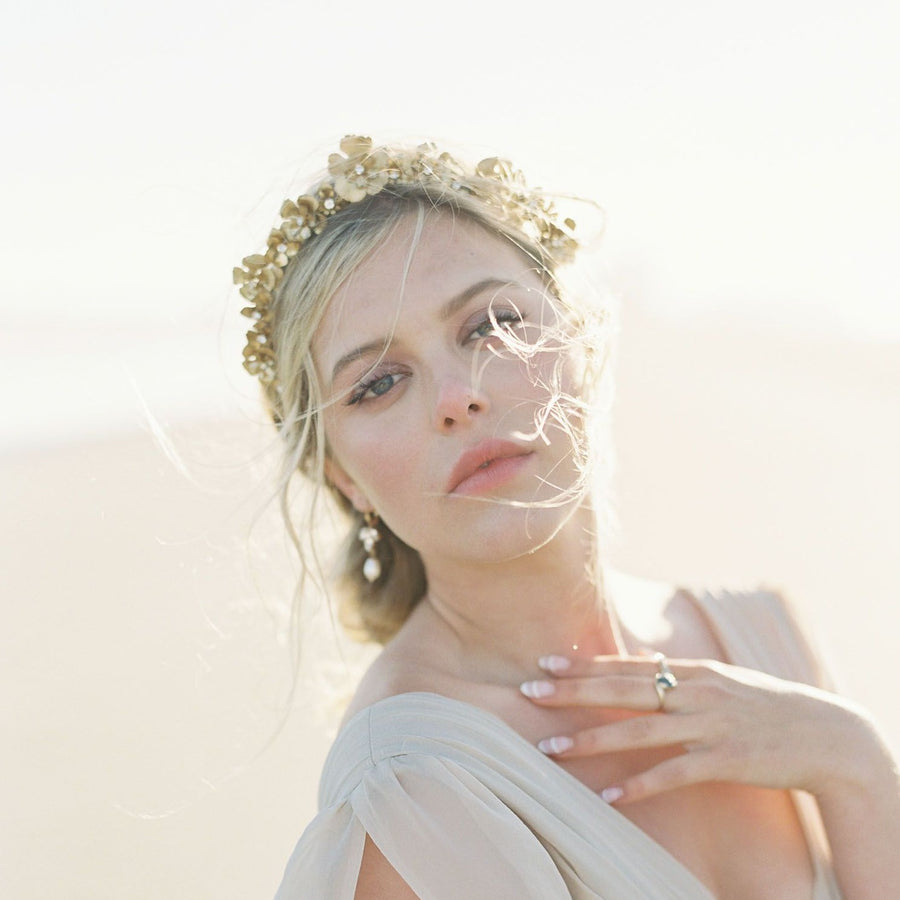 A picture of the most romantic bridal flower crown being worn by a beautiful bride with a messy updo. 