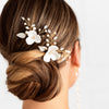 A bride with elegant bridal updo wearing a set of luxury bridal hairpins handmade by Joanna Bisley Designs.