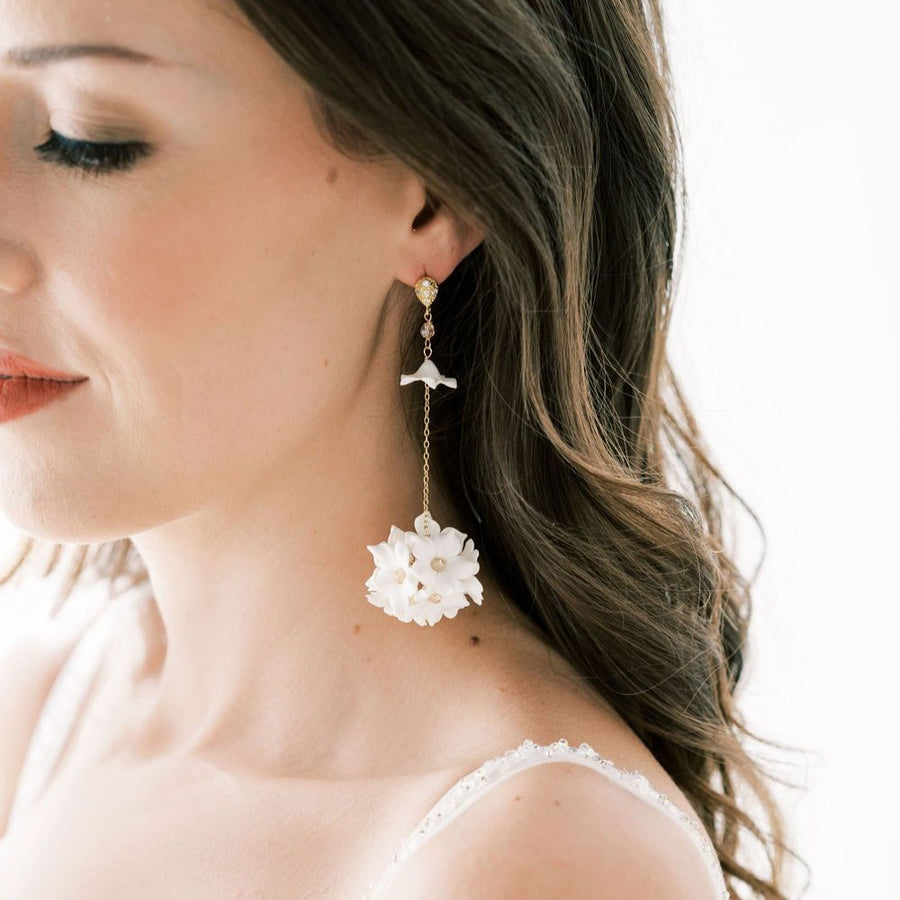 Bride has her eyes closed, wearing beautiful long statement earrings by Joanna Bisley Designs. 