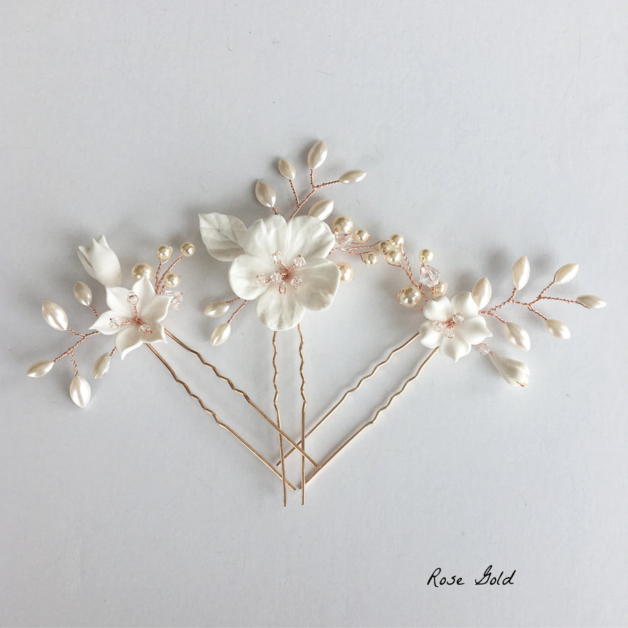 Exquisite bridal pins made with rose gold, pearls and clay flowers.
