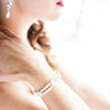 Bride wearing a double strand pearl and crystal cuff bridal bracelet by Joanna Bisley Designs.