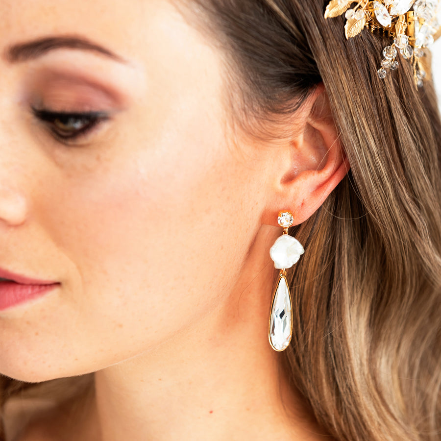 Modern bride wearing a Swarovski Crystal bridal earring that features a baroque Pearl. 