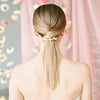 Bride wearing a pearl comb with her bridal ponytail.