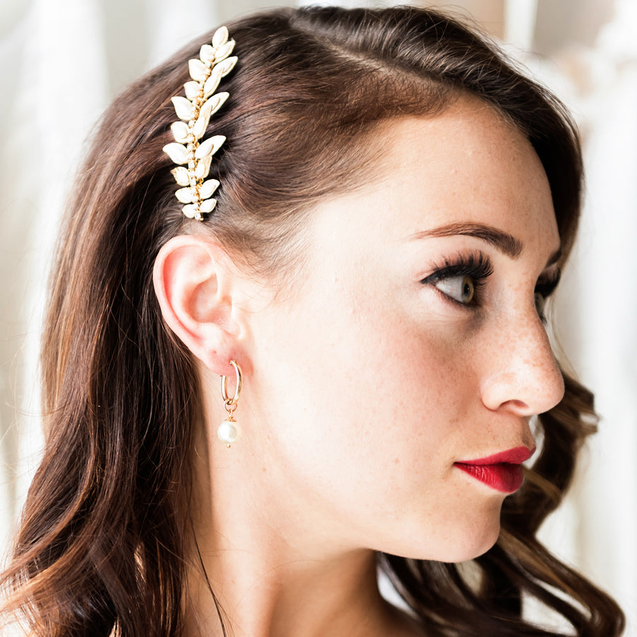 Bride wearing a matching bridal hair comb and pearl hoop wedding earrings in gold. Handcrafted by Joanna Bisley Designs.