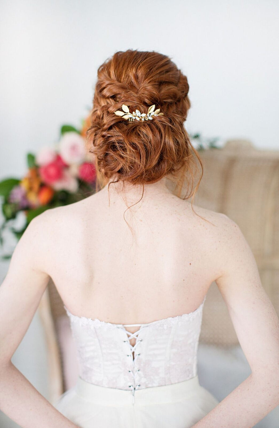 Bride with a romantic bridal updo wearing a beautiful leaf bridal haircomb in her hair.