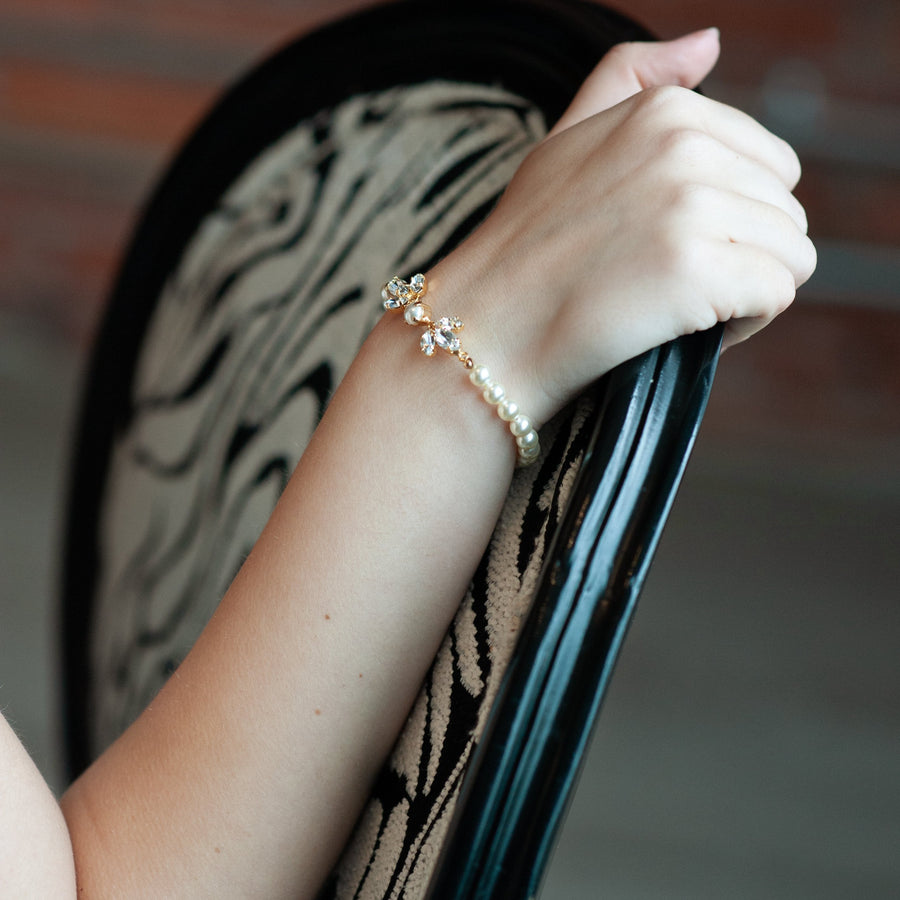 Close up of bride’s arm with a crystal and Pearl bridal bracelet handmade in Canada by Joanna Bisley Designs.