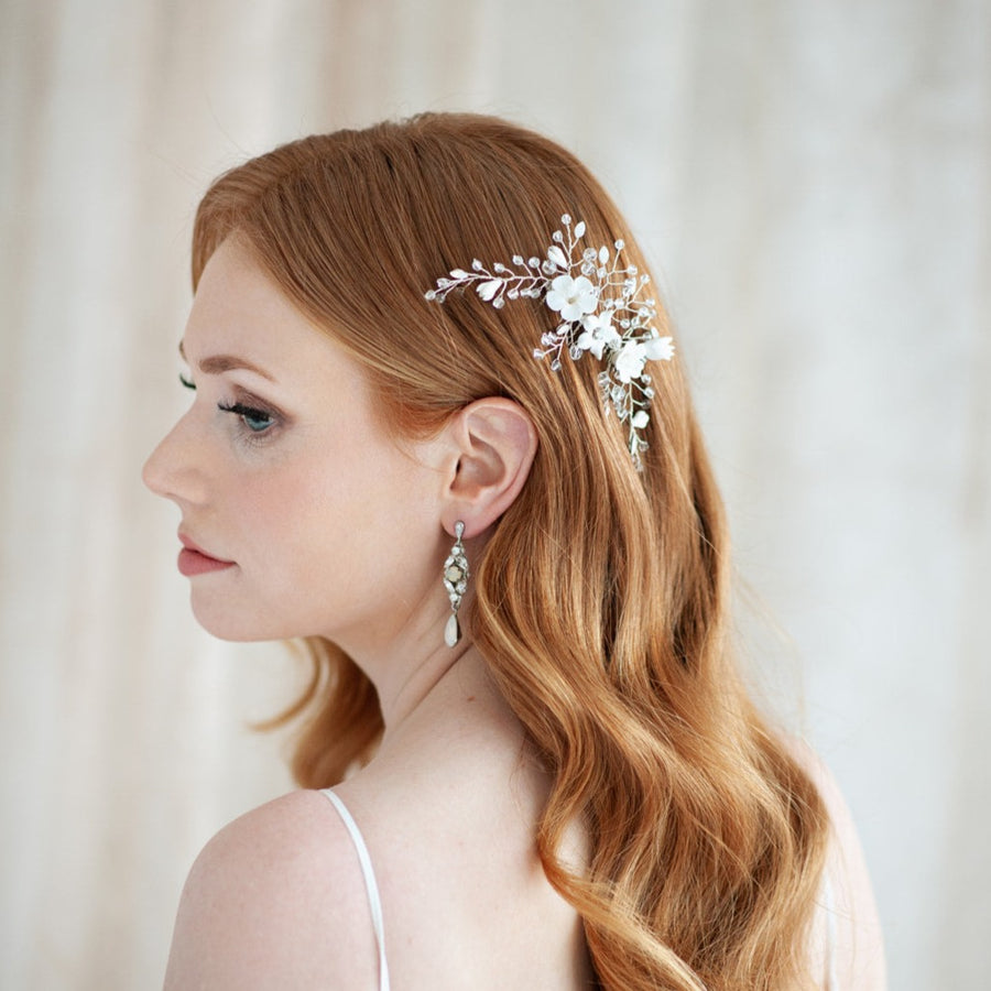 A picture of bride with long Hollywood Waves wearing a white opal bridal hair comb. 