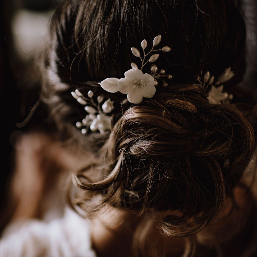 Bride with loose bridal updo with wedding hairpins
