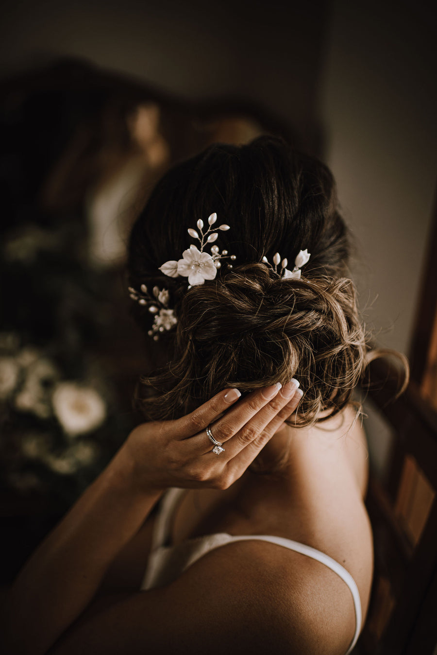 Bride with romantic updo wearing flower and pearl bridal pins by Joanna Bisley Designs.